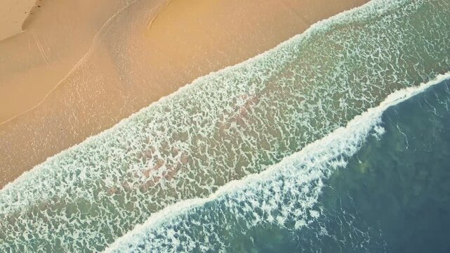 Aerial top view of ocean waves along sandy shoreline, serene coastal retreat with blue sea, beach tranquility and scenic seascape beauty at Koh kood Thailand