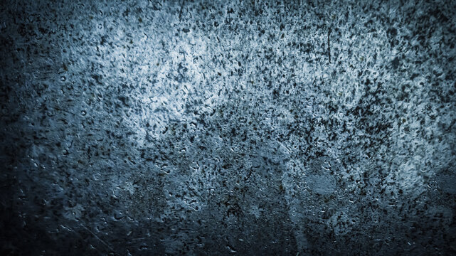 a textured, corroded blue gray metal surface with scattered patches of rust and sheen. abstract banner. grunge aesthetic industrial background banner with copy space.