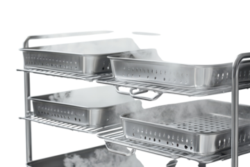 Close up of a stainless steel sterilization cart with steam coming from the trays