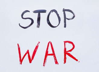 A white poster of stop war, black and red letters on a light background. Poster with text, no war, stop painted with paints for use in articles, magazines and newspapers