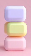 Stacked colorful soaps on a pink background, minimalist design.