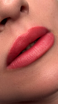 High-resolution close-up image of a woman's lips after a professional permanent makeup (PMU) lip blush procedure