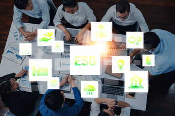 A diverse team collaborates in a modern office, discussing ESG strategies. Visual icons emphasize sustainability, social responsibility, and governance in their planning. Trope