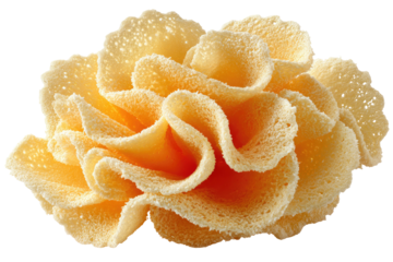 Delicate creamy flower composed of ruffled edible wafers, warm color scheme