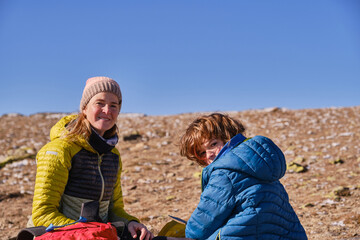 Portrait of a mother and her son resting in the mountains