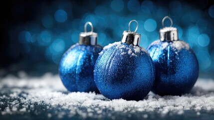 Festive Blue Christmas Ornaments in Snowy Winter Setting with Glittering Lights