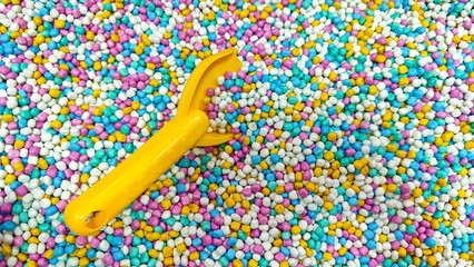 Shovel on the colourful Sand Pool in a playground. Playground indoors.