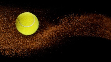 Freeze Motion Shot of Flying Tennis Ball with Clay , Isolated on Black Background