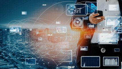 A business professional checks their smartphone amidst vibrant digital data visualizations over a modern city skyline at dusk, embodying innovation and technology. Xenic