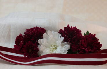 Red-white-red ribbon in the colours of the Latvian national flag. Independence Day in November.