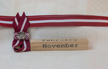 Red-white-red ribbon in the colours of the Latvian national flag. Independence Day in November.