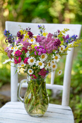 Glass vase with beautiful bouquet of summer flowers