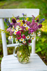 Glass vase with beautiful bouquet of summer flowers
