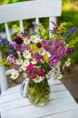 Glass vase with beautiful bouquet of summer flowers