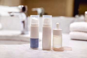 Face cream and face serum in a modern bathroom  
