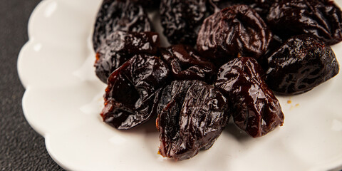 Prunes smoked plum portion size natural product tasty snack fresh delicious gourmet food background on the table rustic top view copy space keto and paleo diet vegetarian and vegan food