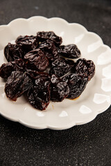 Prunes smoked plum portion size natural product tasty snack fresh delicious gourmet food background on the table rustic top view copy space keto and paleo diet vegetarian and vegan food