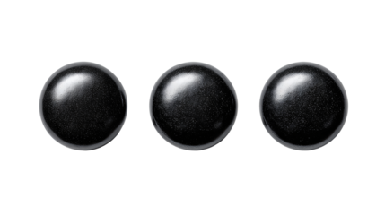 Ceramic dot trio in deep black glaze with balanced spacing and graduated sizing, sleek reflective highlights, isolated on transparent background
