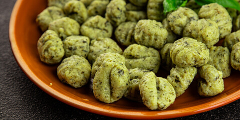Gnocchi spinach potato dough second course portion size natural product tasty snack fresh delicious gourmet food background on the table rustic top view copy space