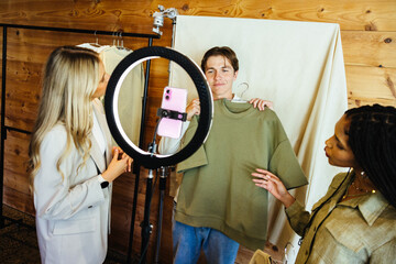 Young team collaborating on a fashion photoshoot for online retail promotion
