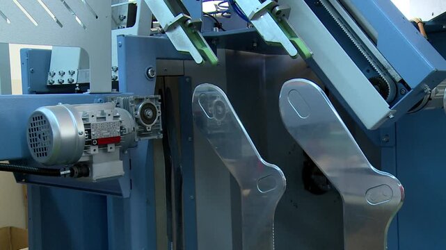 High-speed industrial circular knitting machine weaves textile threads with precision. Complex mechanical parts show modern automated production and efficiency in textile manufacturing.