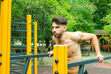 Fototapeta premium Man working out in Calisthenics Park