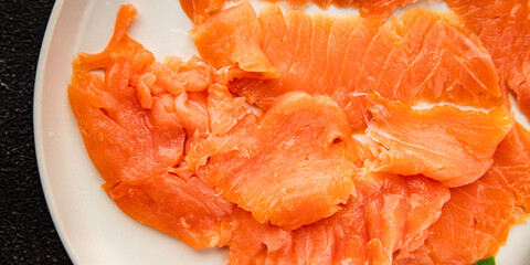 Smoked salmon fish seafood portion size natural product tasty snack fresh delicious gourmet food background on the table rustic top view copy space pescetarian diet