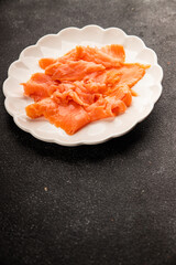 Smoked salmon fish seafood portion size natural product tasty snack fresh delicious gourmet food background on the table rustic top view copy space pescetarian diet