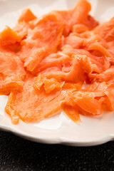 Smoked salmon fish seafood portion size natural product tasty snack fresh delicious gourmet food background on the table rustic top view copy space pescetarian diet
