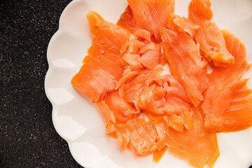 Smoked salmon fish seafood portion size natural product tasty snack fresh delicious gourmet food background on the table rustic top view copy space pescetarian diet