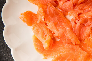 Smoked salmon fish seafood portion size natural product tasty snack fresh delicious gourmet food background on the table rustic top view copy space pescetarian diet