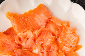 Smoked salmon fish seafood portion size natural product tasty snack fresh delicious gourmet food background on the table rustic top view copy space pescetarian diet