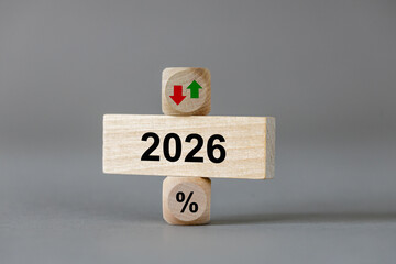 2026. The symbol of a percentage. Wooden blocks with arrows symbolizing growth or decline. Business concept. copy space