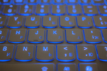Blue backlit keyboard with English and Cyrillic keys.