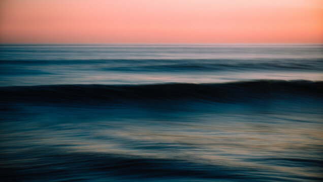 Abstract motion blur ocean and sky, dreamy golden hour haze