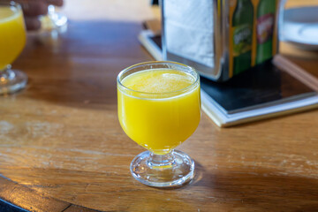 Glass full of orange poncha in Madeira, Portugal