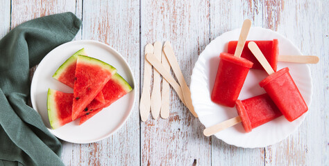Red watermelon popsicle ice cream on a plate on the table top view web banner