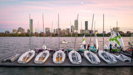 The skyline of Boston in Massachusetts at night as seen from Memorial Driver Road in Cambridge, MA, USA with the famous Charles river in between the two cities.