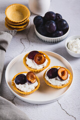 Mini baking with ricotta and berries on a plate on the table vertical view