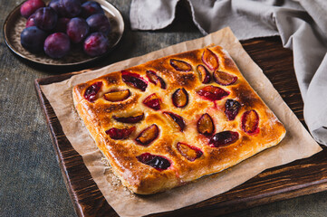 Sweet homemade focaccia with berries on paper on the table