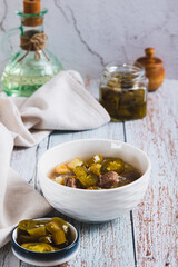 Delicious cabbage soup with beef and jalapenos in a bowl on the table vertical view