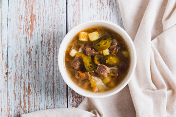 Close up of delicious cabbage soup with beef and jalapenos in a bowl on the table top view
