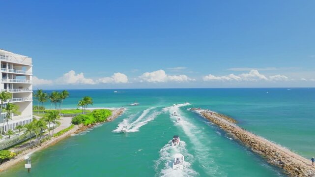aerial drone view of Boca Raton, Florida inlet with boats in ocean