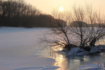 Golden sunset on winter river