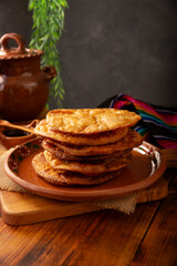 Mexican Buñuelos. Traditionally fried wheat tortillas used for Christmas and winter holidays, these are fried flour tortillas sprinkled with sugar or covered in a syrup made with piloncillo, cinnamon,