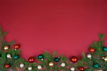 Red background of Christmas branches and Christmas tree decorations