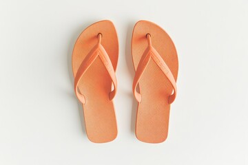 Bright orange flip flops laid out on a light background for casual summer fashion promotion