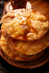 Mexican Buñuelos. Traditionally fried wheat tortillas used for Christmas and winter holidays, these are fried flour tortillas sprinkled with sugar or covered in a syrup made with piloncillo, cinnamon,