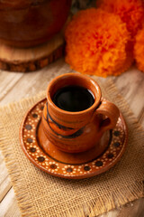 Cafe de Olla, traditional black Mexican coffee, spiced with cinnamon and piloncillo, prepared in a pot and served in a handmade clay cup called a jarrito.