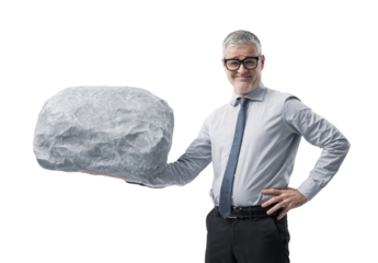 A Confident Businessman Lifting a Heavy Boulder with One Hand and Smiling at the Camera